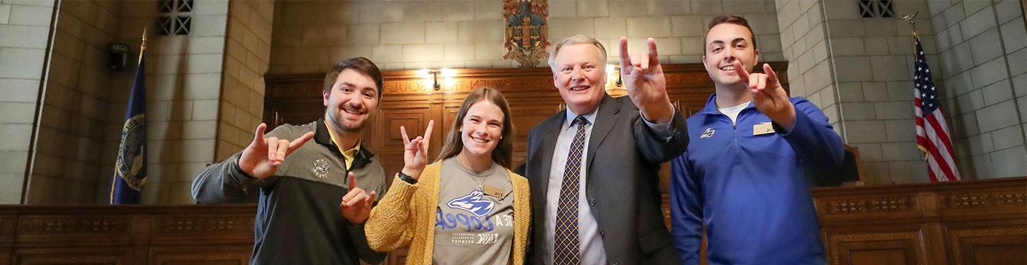 student government representatives pose with Chancellor Kristensen  at the state capitol