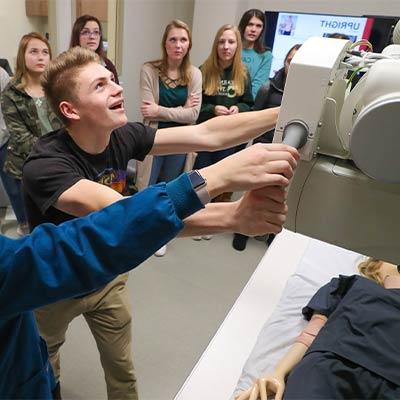 a student uses medical equipment during a demonstration