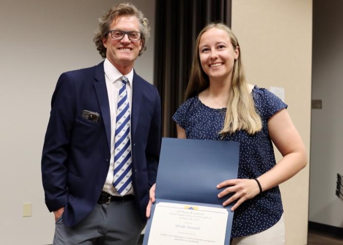 Man presenting a woman award.